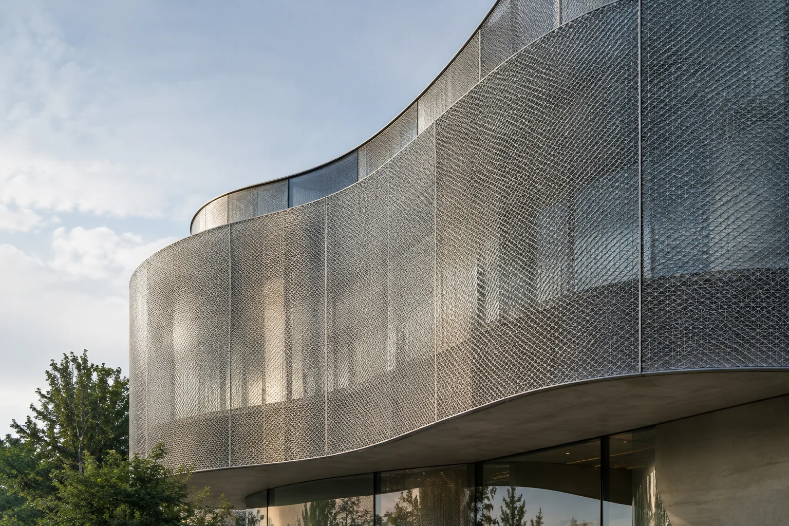 Thin geometric cladding panel conforming to a curved contemporary facade