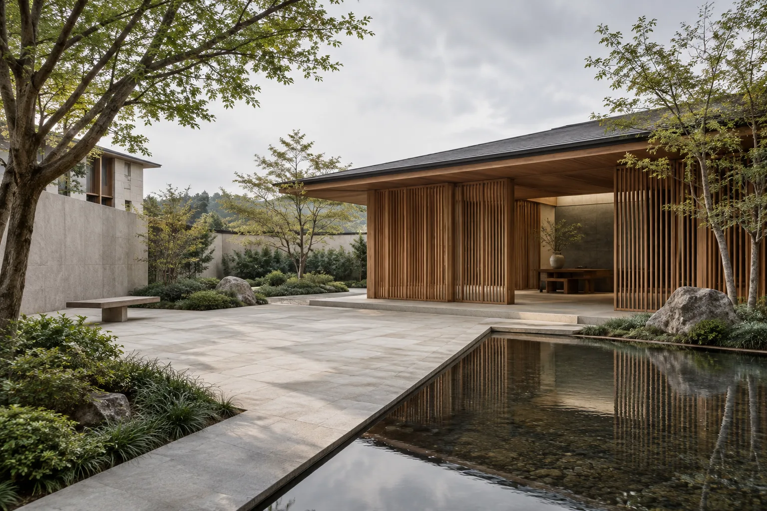Stone-paved courtyard of a contemporary cultural building, with timber screens and soft daylight